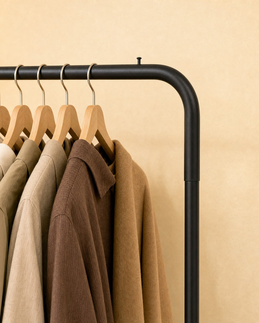 Clothing Stand with 1 Shoe Rack & 2 Bag Holders - close-up of the rounded top corner, in a living room