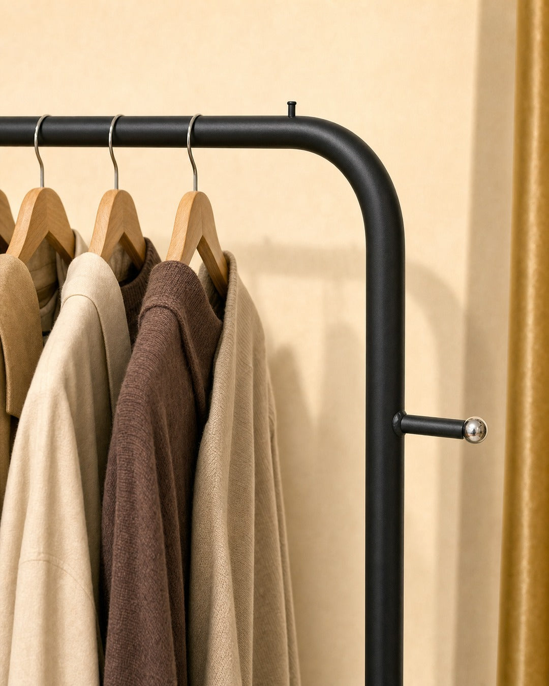 Clothing Stand with 2 Shoe Racks & 2 Bag Holders - close-up of the rounded top corner, in a living room